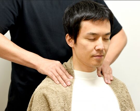 I am giving him a shoulder massage